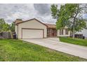 Traditional home with a spacious driveway, attached garage and inviting lawn at 18240 E Mexico Pl, Aurora, CO 80017