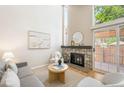 Inviting living room with a stone fireplace, neutral decor, and natural light streaming in at 2910 S Racine St, Aurora, CO 80014