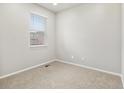 Bright and airy bedroom with neutral carpet, a large window with blinds, and light gray walls at 559 Homestead Ave, Brighton, CO 80601