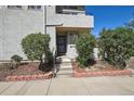 The front entrance features a neutral exterior, clean landscaping, and a short walk up to the front door at 1830 Newland Ct # 101, Lakewood, CO 80214