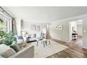 Bright and airy living room featuring hardwood floors, neutral décor, and comfortable seating at 470 S Queen St, Lakewood, CO 80226