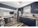An inviting kitchen and open living area with stainless steel refrigerator and ample natural light at 7296 Quivas St, Denver, CO 80221