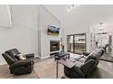 Bright living room boasts a fireplace and sliding doors leading to a private outdoor patio at 1160 S Monaco Pkwy # 6, Denver, CO 80224