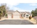 Charming single-story home with a three-car garage and well-maintained landscaping at 14850 Akron St, Brighton, CO 80602