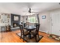 Bright dining area with hardwood floors, a brick fireplace, and large windows offering ample natural light at 2612 Meadowbrook Dr, Denver, CO 80221