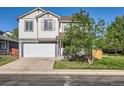 Charming two-story home with a well-maintained lawn and attached two-car garage at 1145 S Boston St, Denver, CO 80247