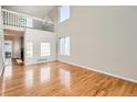 Bright living room with soaring ceilings, hardwood floors, and large windows at 1145 S Boston St, Denver, CO 80247
