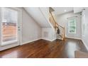 Entryway with hardwood floors, staircase, and natural light from door and window at 2230 Valentia St, Denver, CO 80238