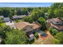 Back yard aerial view of a well-maintained home with mature trees and a storage shed at 6411 W 82Nd Dr, Arvada, CO 80003