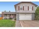 Beautiful exterior featuring a well-manicured lawn and two-car garage at 5255 S Waco St, Centennial, CO 80015