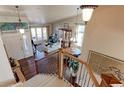 Elegant staircase leading to the upper level, overlooking the living area at 14307 Waterside Ln, Broomfield, CO 80023