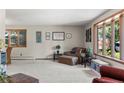 Spacious living room with neutral colors, large windows, and two cozy armchairs at 8571 W 71St Cir, Arvada, CO 80004