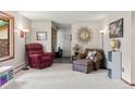 Cozy living room with neutral carpet, a large window, and comfortable seating at 8571 W 71St Cir, Arvada, CO 80004