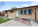 Lovely home featuring a brick facade, well-manicured landscaping, and a welcoming entrance at 1470 S Yates St, Denver, CO 80219