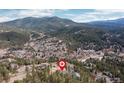 A bird's-eye view highlights the mountain scenery surrounding the property at 26456 Sweetbriar Trl, Evergreen, CO 80439