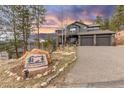 Welcome to 26456 Sweetbriar Trail, a stunning mountain home with beautiful landscaping and a two car garage at 26456 Sweetbriar Trl, Evergreen, CO 80439