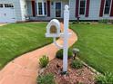 Lovely curb appeal with a decorative mailbox, a manicured lawn, and a charming stone walkway leading to the entrance at 16308 E Wyoming Dr, Aurora, CO 80017