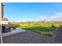 Large backyard with patio, firepit, and grassy area at 16198 E 111Th Pl, Commerce City, CO 80022