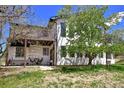 Inviting backyard with outdoor seating area and a second story balcony overlooking the well-maintained lawn at 1673 Woodmoor Dr, Monument, CO 80132