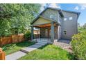 Two-story home featuring a cozy front porch and landscaped front yard at 3770 Osceola St, Denver, CO 80212
