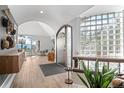Warm foyer with hardwood floors, glass block window, and views to a seating area at 24798 Foothills N Dr, Golden, CO 80401