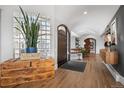 Inviting foyer with hardwood floors, a wood chest, and decorative doorway at 24798 Foothills N Dr, Golden, CO 80401