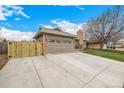 Wide driveway and an attached garage with a fence in the background at 3170 S Princess Cir, Broomfield, CO 80020