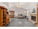 Spacious living room with a brick fireplace, carpeted floor and vaulted ceilings at 3170 S Princess Cir, Broomfield, CO 80020
