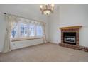 Bright living room with fireplace and bay window at 6055 W Warren Pl, Lakewood, CO 80227