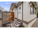 Charming front entrance with new lights, a wooden fence, and concrete steps at 3015 Pierce St, Wheat Ridge, CO 80214