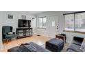 Bright living room with light hardwood floors, large windows and comfortable furniture at 950 Jasmine St, Denver, CO 80220