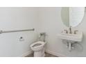 Half bath features a modern toilet and sink, with accessibility support at 11493 E Briarwood Cir, Centennial, CO 80112
