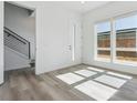 Well-lit living room with hardwood floors, staircase and modern design elements at 11493 E Briarwood Cir, Centennial, CO 80112
