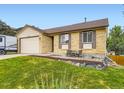 Lovely single-Gathering home with a brick facade, attached garage, and a nicely landscaped front yard at 2104 Vineyard Dr, Castle Rock, CO 80104
