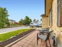 Inviting front porch area featuring a brick tile surface and a comfortable outdoor seating set at 2104 Vineyard Dr, Castle Rock, CO 80104