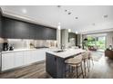 Modern kitchen with stainless steel appliances, gray cabinets, and large center island at 4200 W 17Th Ave # 212, Denver, CO 80204