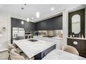 Elegant kitchen features stainless steel appliances, gray cabinets, and an island with bar seating at 4200 W 17Th Ave # 212, Denver, CO 80204
