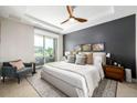 Relaxing main bedroom with gray accent wall, ceiling fan, and lots of natural light at 4200 W 17Th Ave # 212, Denver, CO 80204