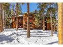 Attractive wood-sided condo building nestled in snowy woods at 1140 Ski Hill Rd # 25, Breckenridge, CO 80424