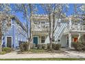 Delightful light blue two-story home featuring a quaint porch and inviting curb appeal at 7453 E 26Th Ave # 2, Denver, CO 80238