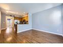 Inviting living space featuring hardwood floors and an open layout to the kitchen at 7453 E 26Th Ave # 2, Denver, CO 80238