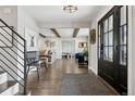 Inviting foyer with hardwood flooring, opening to a living area with beamed ceilings and stylish furnishings at 7152 E Hinsdale Pl, Centennial, CO 80112