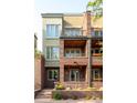 Charming multi-story townhome featuring brick and stucco facade, and multiple balconies at 907 E 22Nd Ave, Denver, CO 80205