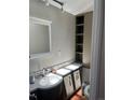 Bathroom featuring a white vanity, white countertops, and cabinet for storage at 819 27Th St, Denver, CO 80205
