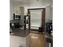 Well-lit kitchen features stainless steel appliances, a brick wall accent, and wood flooring at 819 27Th St, Denver, CO 80205