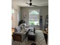 Living room with gray couch, ceiling fan, and lots of natural light at 819 27Th St, Denver, CO 80205