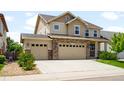 Inviting two-story home with a spacious three-car garage and a beautifully landscaped front yard at 1339 Sidewinder Cir, Castle Rock, CO 80108