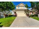 Charming two-story home with attached garage and inviting curb appeal with green lawn at 5972 S Zante Way, Aurora, CO 80015