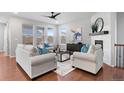 Bright living room features large windows, hardwood floors, and a cozy fireplace at 10049 Isle St, Parker, CO 80134