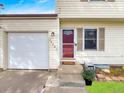 Welcoming entrance with a red door, attached garage, and colorful flower accents at 10781 Moore St, Westminster, CO 80021